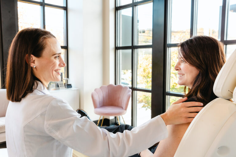A provider in a lab coat explains the benefits of Pure Plasma in Nashville
